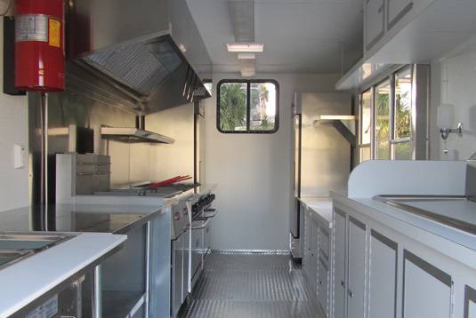 A kitchen with many cabinets and counters in it