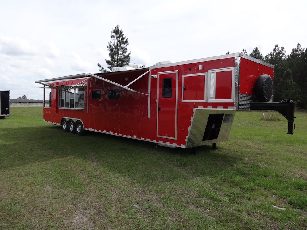 A red trailer with a large open area.