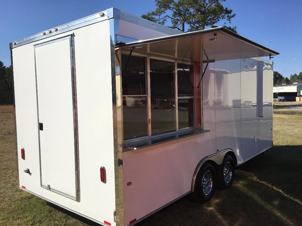 A white trailer with a window open on the back.